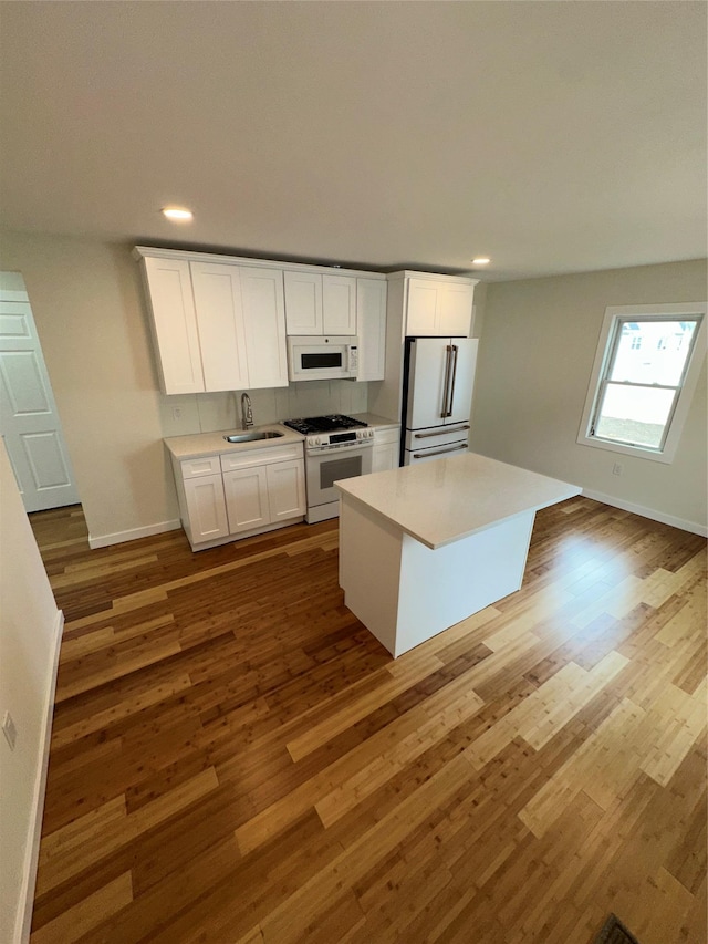 84 Windsor, Hempstead, NY 11550 - kitchen featuring white appliances, a sink, wood finished floors, and recessed lighting