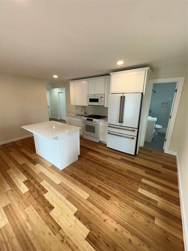 84 Windsor, Hempstead, NY 11550 - kitchen with white appliances, a sink, recessed lighting, light wood-style flooring, and white cabinetry