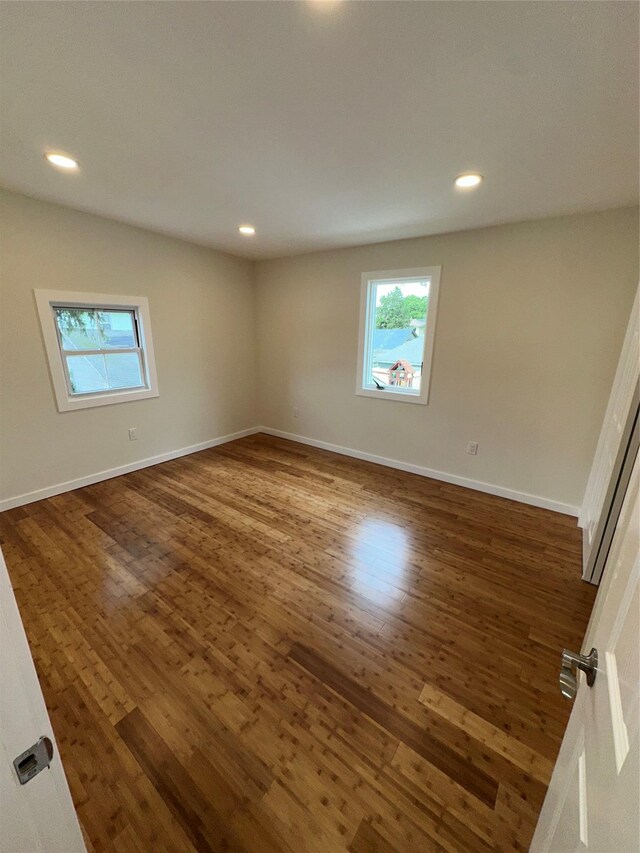 84 Windsor, Hempstead, NY 11550 - empty room with dark wood-style floors, healthy amount of natural light, baseboards, and recessed lighting