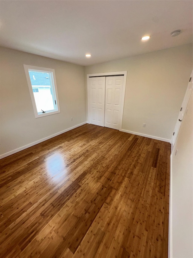 84 Windsor, Hempstead, NY 11550 - unfurnished bedroom featuring dark wood finished floors, baseboards, recessed lighting, and a closet
