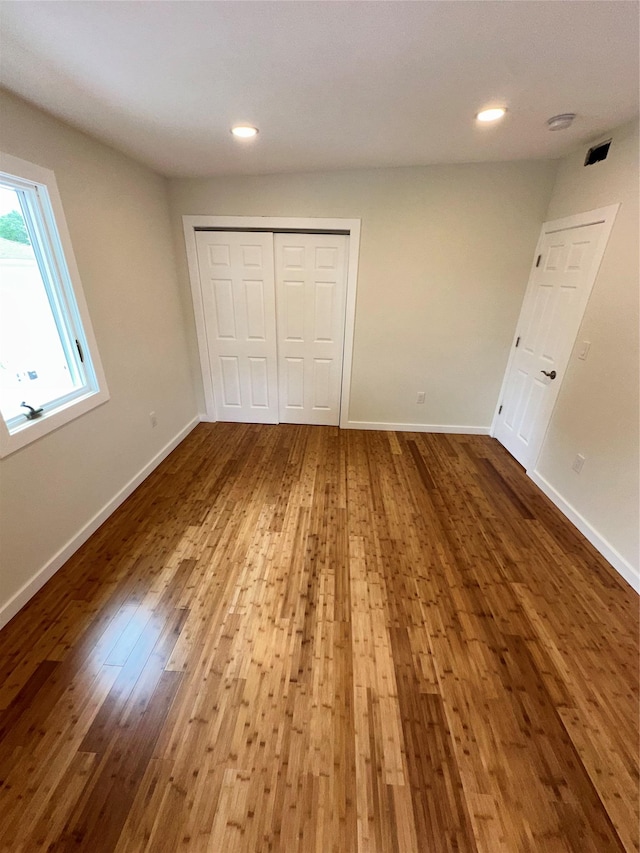 84 Windsor, Hempstead, NY 11550 - unfurnished bedroom featuring hardwood / wood-style floors, baseboards, a closet, and recessed lighting