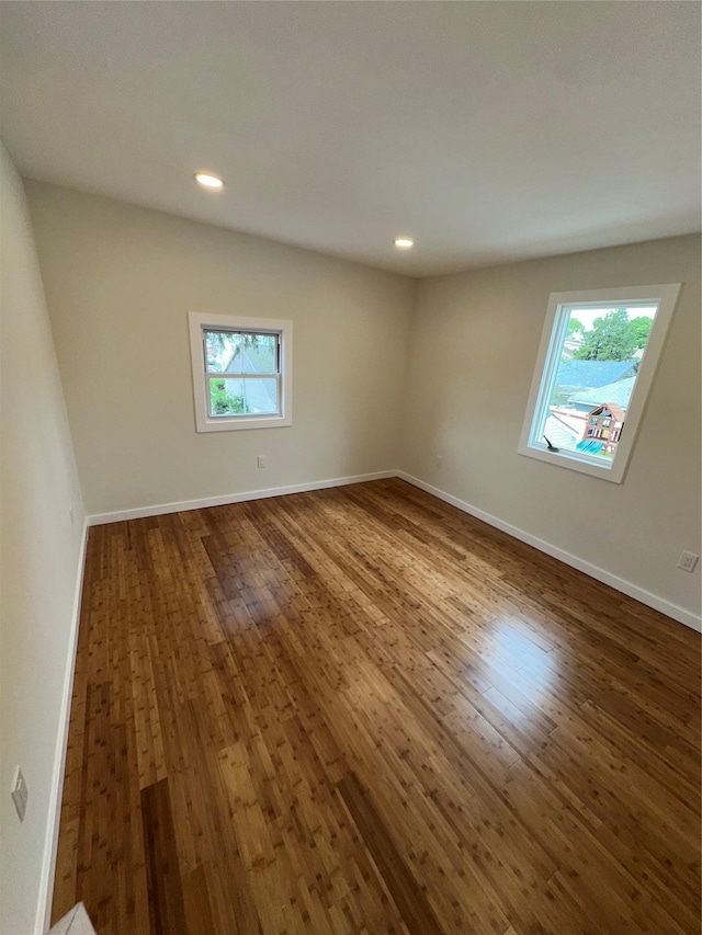 84 Windsor, Hempstead, NY 11550 - empty room with dark wood finished floors, healthy amount of natural light, recessed lighting, and baseboards