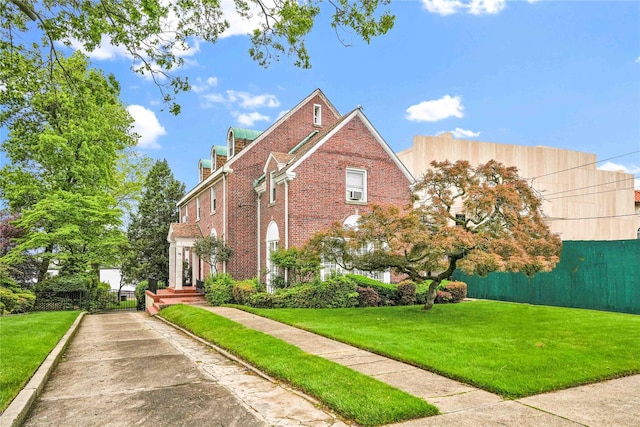 95 Malba Dr Unit 1, Malba, NY 11357 - view of home's exterior with brick siding, a lawn, and a chimney