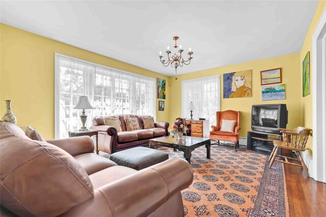 95 Malba Dr Unit 1, Malba, NY 11357 - living room with a chandelier, a baseboard heating unit, and wood finished floors