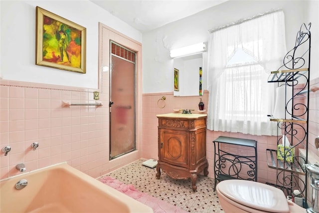 95 Malba Dr Unit 1, Malba, NY 11357 - full bathroom with tile walls, wainscoting, a stall shower, vanity, and a garden tub