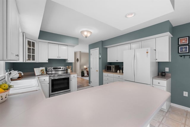 1 Bray Farm Ln, Wappingers Falls, NY 12590 - kitchen featuring stainless steel appliances, a sink, a peninsula, white cabinets, and baseboards