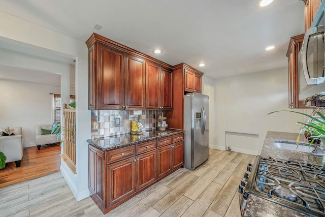1668 Atherton Ave, Elmont, NY 11003 - kitchen with stainless steel fridge, light wood-type flooring, baseboards, dark stone counters, and recessed lighting