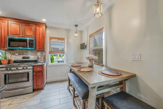 1668 Atherton Ave, Elmont, NY 11003 - kitchen with stainless steel appliances, decorative backsplash, pendant lighting, light wood-style floors, and recessed lighting