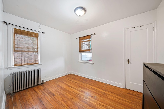 1668 Atherton Ave, Elmont, NY 11003 - spare room featuring radiator heating unit, light wood finished floors, and baseboards