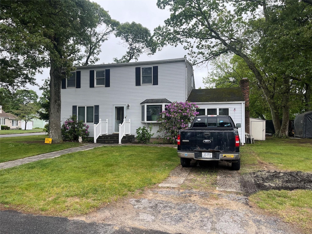 18 Bonnybill Dr, Centereach, NY 11720 - colonial inspired home featuring a front lawn and a chimney