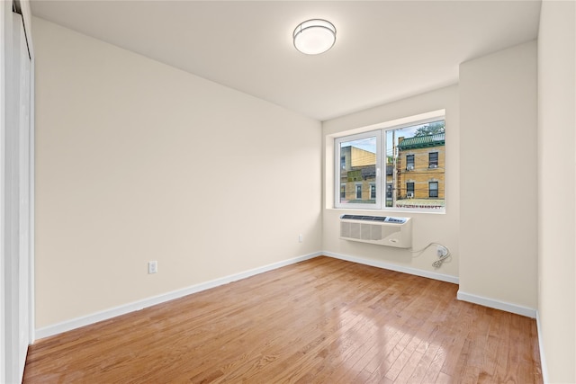 91-23 Corona Ave Unit 2F, Elmhurst, NY 11373 - unfurnished room featuring a wall unit AC, light wood finished floors, and baseboards