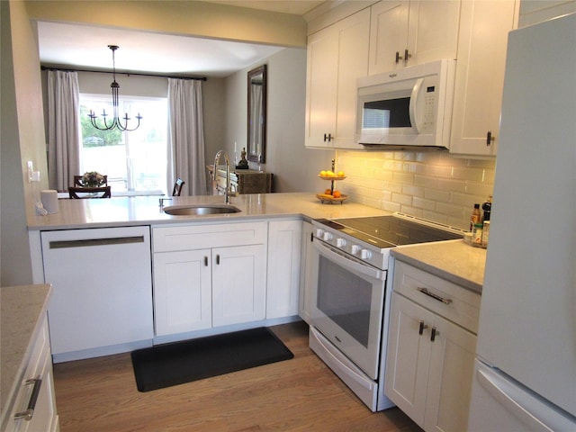 44 Vanderburgh Rd, Poughquag, NY 12570 - kitchen featuring white appliances, a sink, wood finished floors, backsplash, and light countertops
