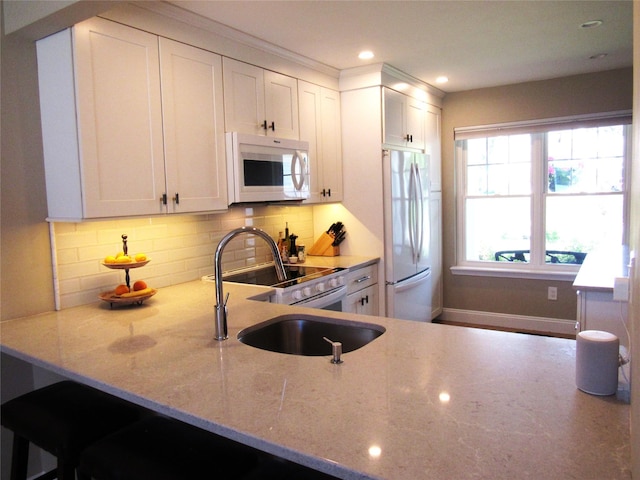 44 Vanderburgh Rd, Poughquag, NY 12570 - kitchen featuring white appliances, light stone counters, backsplash, white cabinets, and recessed lighting