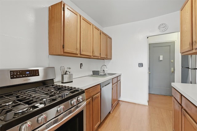 70 Sherman Ave Unit 2G, Yonkers, NY 10705 - kitchen with stainless steel appliances, light countertops, light wood-style flooring, and a sink