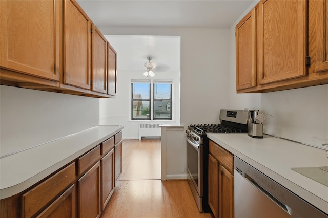 70 Sherman Ave Unit 2G, Yonkers, NY 10705 - kitchen with radiator heating unit, stainless steel appliances, light countertops, light wood-type flooring, and ceiling fan