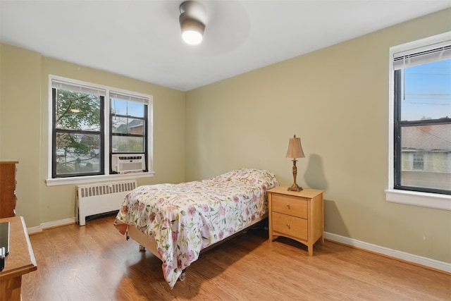 70 Sherman Ave Unit 2G, Yonkers, NY 10705 - bedroom featuring radiator heating unit, light wood finished floors, baseboards, cooling unit, and a ceiling fan