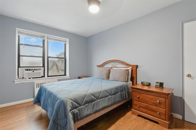 70 Sherman Ave Unit 2G, Yonkers, NY 10705 - bedroom featuring baseboards, light wood-style floors, cooling unit, and radiator