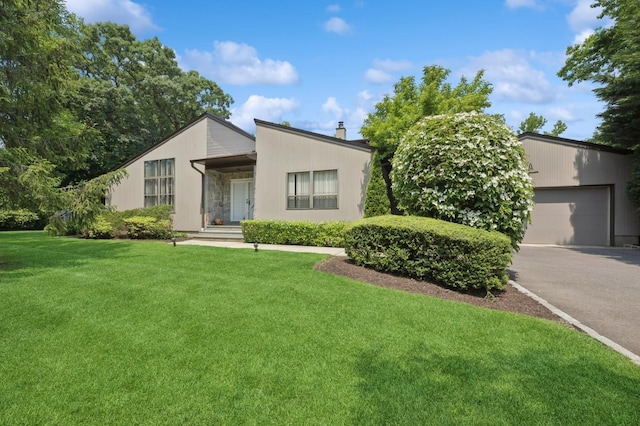 15 Augusta Ln, Manhasset, NY 11030 - mid-century modern home featuring driveway, a front lawn, stone siding, an attached garage, and a chimney