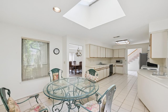 15 Augusta Ln, Manhasset, NY 11030 - dining space featuring light tile patterned floors, a skylight, and recessed lighting