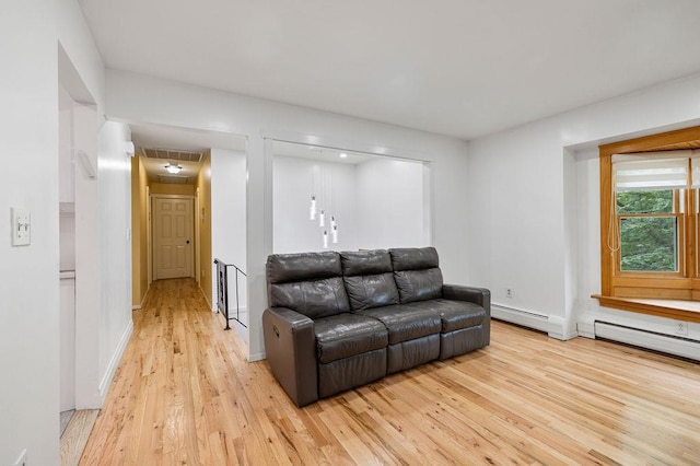 10 Karow Ct, Monsey, NY 10952 - living room with light wood-style flooring, baseboard heating, and baseboards