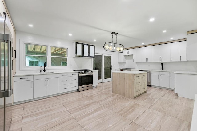 10 Karow Ct, Monsey, NY 10952 - kitchen featuring stainless steel appliances, a sink, a center island, recessed lighting, and white cabinets