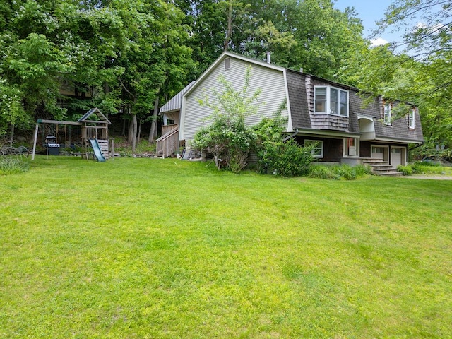 10 Karow Ct, Monsey, NY 10952 - view of green lawn with a garage, a playground, and view of scattered trees