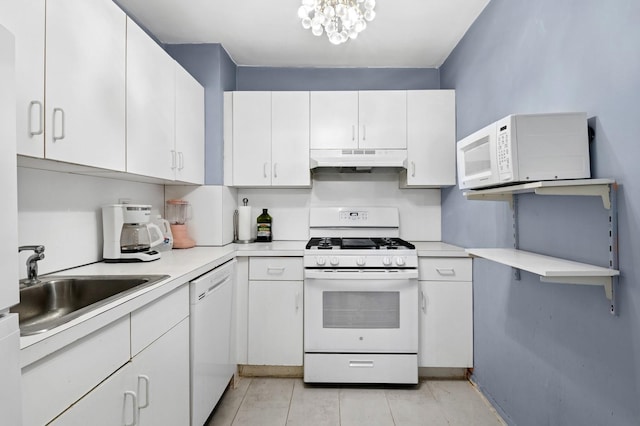 125-10 Queens Blvd Unit 14-25, Kew Gardens, NY 11415 - kitchen with white appliances, under cabinet range hood, light countertops, a sink, and white cabinets