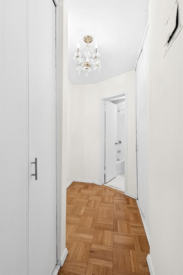 125-10 Queens Blvd Unit 14-25, Kew Gardens, NY 11415 - corridor with a chandelier and baseboards