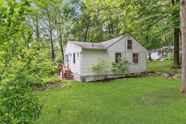 3300 Baker Unit 11, Mohegan Lake, NY 10547 - view of property exterior featuring a lawn and roof with shingles