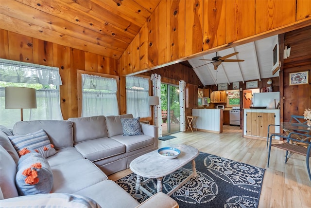 3300 Baker Unit 11, Mohegan Lake, NY 10547 - living area featuring vaulted ceiling, light wood-type flooring, wood walls, and ceiling fan