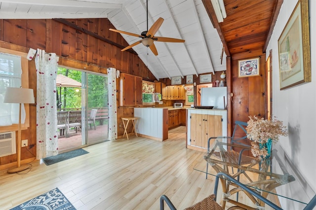 3300 Baker Unit 11, Mohegan Lake, NY 10547 - kitchen featuring a peninsula, wood walls, light wood-style flooring, tile counters, and ceiling fan