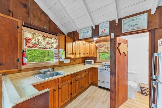 3300 Baker Unit 11, Mohegan Lake, NY 10547 - kitchen with white gas range oven, a sink, light countertops, light wood-type flooring, and wood ceiling