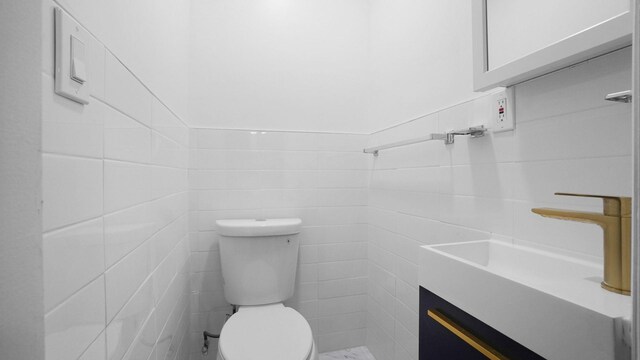 2448 Webb Ave, Bronx, NY 10468 - half bathroom featuring tile walls, vanity, and toilet