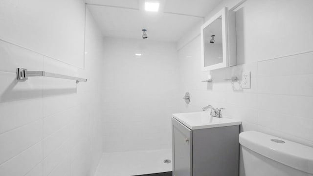 2448 Webb Ave, Bronx, NY 10468 - full bathroom featuring vanity, a tile shower, tile walls, and toilet