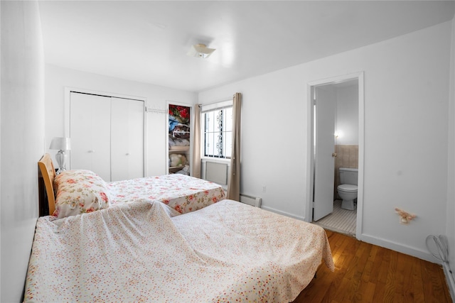 45-53 Parsons Blvd, Flushing, NY 11355 - bedroom with baseboards, wood finished floors, a closet, ensuite bathroom, and a baseboard heating unit