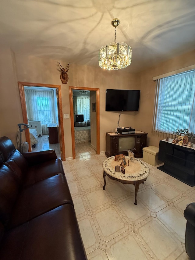 7542 67th Rd, Middle Village, NY 11379 - living area with a chandelier, baseboards, and light flooring