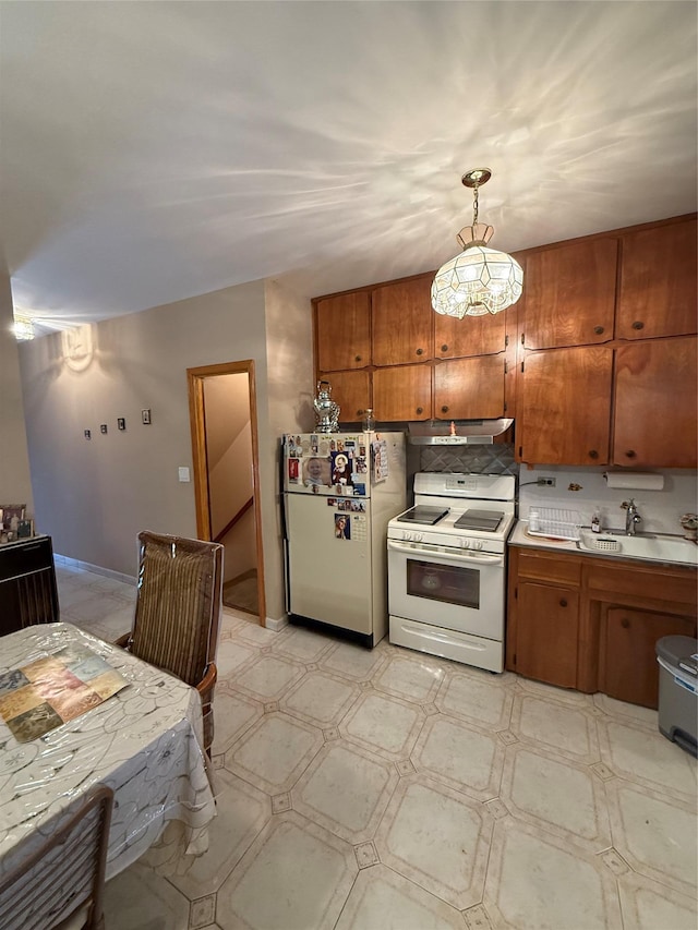 7542 67th Rd, Middle Village, NY 11379 - kitchen featuring white appliances, a sink, brown cabinetry, light floors, and under cabinet range hood
