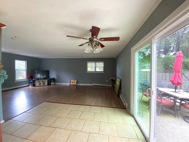 186 Montrose Dr, Port Jefferson Station, NY 11776 - living room with baseboard heating, a ceiling fan, and light wood finished floors