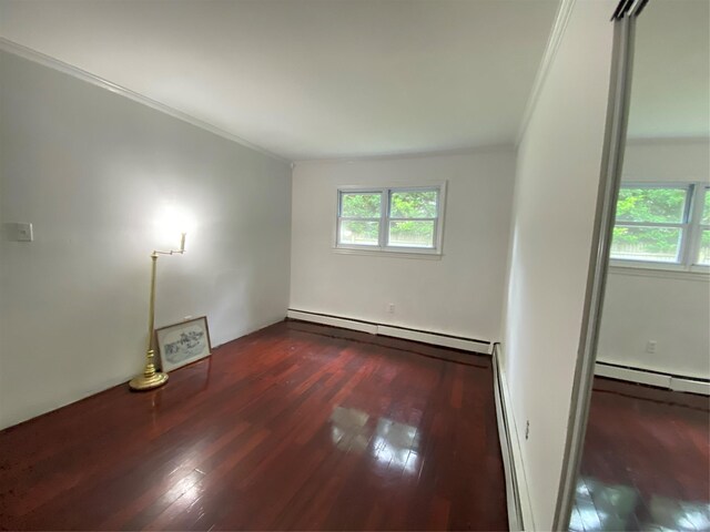 186 Montrose Dr, Port Jefferson Station, NY 11776 - empty room with baseboard heating, plenty of natural light, crown molding, and wood finished floors