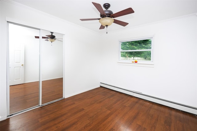 186 Montrose Dr, Port Jefferson Station, NY 11776 - unfurnished bedroom featuring a baseboard heating unit, crown molding, wood finished floors, a closet, and a ceiling fan