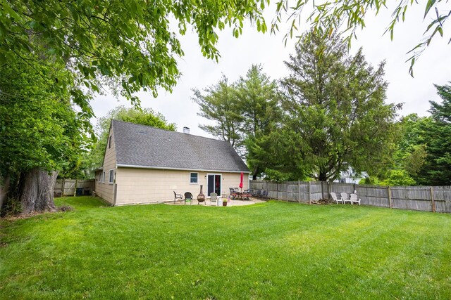 186 Montrose Dr, Port Jefferson Station, NY 11776 - rear view of property featuring a patio, a shingled roof, and a chimney