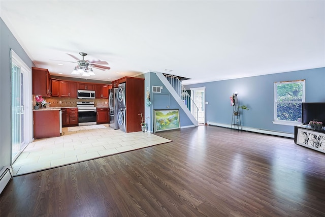 186 Montrose Dr, Port Jefferson Station, NY 11776 - unfurnished living room featuring stairs, baseboard heating, light wood-style floors, and a ceiling fan