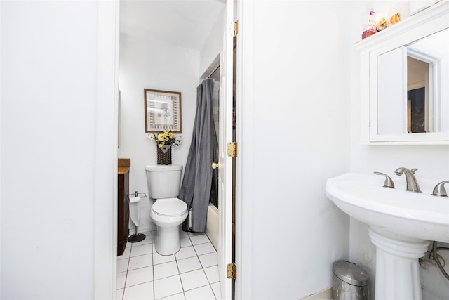 186 Montrose Dr, Port Jefferson Station, NY 11776 - bathroom featuring tile patterned floors, toilet, a sink, and shower / bath combination with curtain