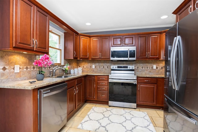 186 Montrose Dr, Port Jefferson Station, NY 11776 - kitchen with appliances with stainless steel finishes, a sink, light stone counters, light tile patterned floors, and backsplash
