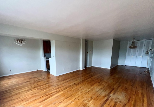 415 Gramatan Ave Unit 5D, Mount Vernon, NY 10552 - empty room with a chandelier, wood finished floors, and baseboards