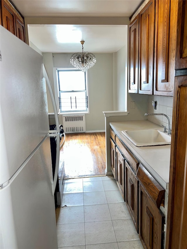 415 Gramatan Ave Unit 5D, Mount Vernon, NY 10552 - kitchen featuring freestanding refrigerator, radiator heating unit, a sink, light countertops, and range