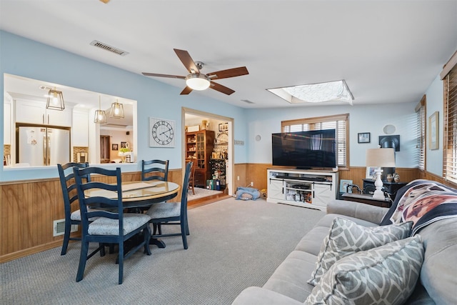 23 Waldron Dr, Stony Point, NY 10980 - living area featuring wainscoting, a skylight, carpet flooring, a ceiling fan, and wooden walls