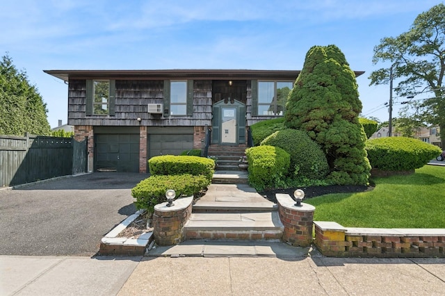 360 Robyn Pl, East Meadow, NY 11554 - split foyer home with asphalt driveway, a garage, brick siding, and cooling unit