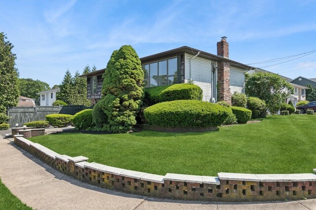 360 Robyn Pl, East Meadow, NY 11554 - view of side of home featuring a chimney