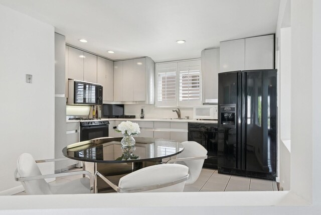 360 Robyn Pl, East Meadow, NY 11554 - kitchen with black appliances, light tile patterned floors, light countertops, recessed lighting, and a sink